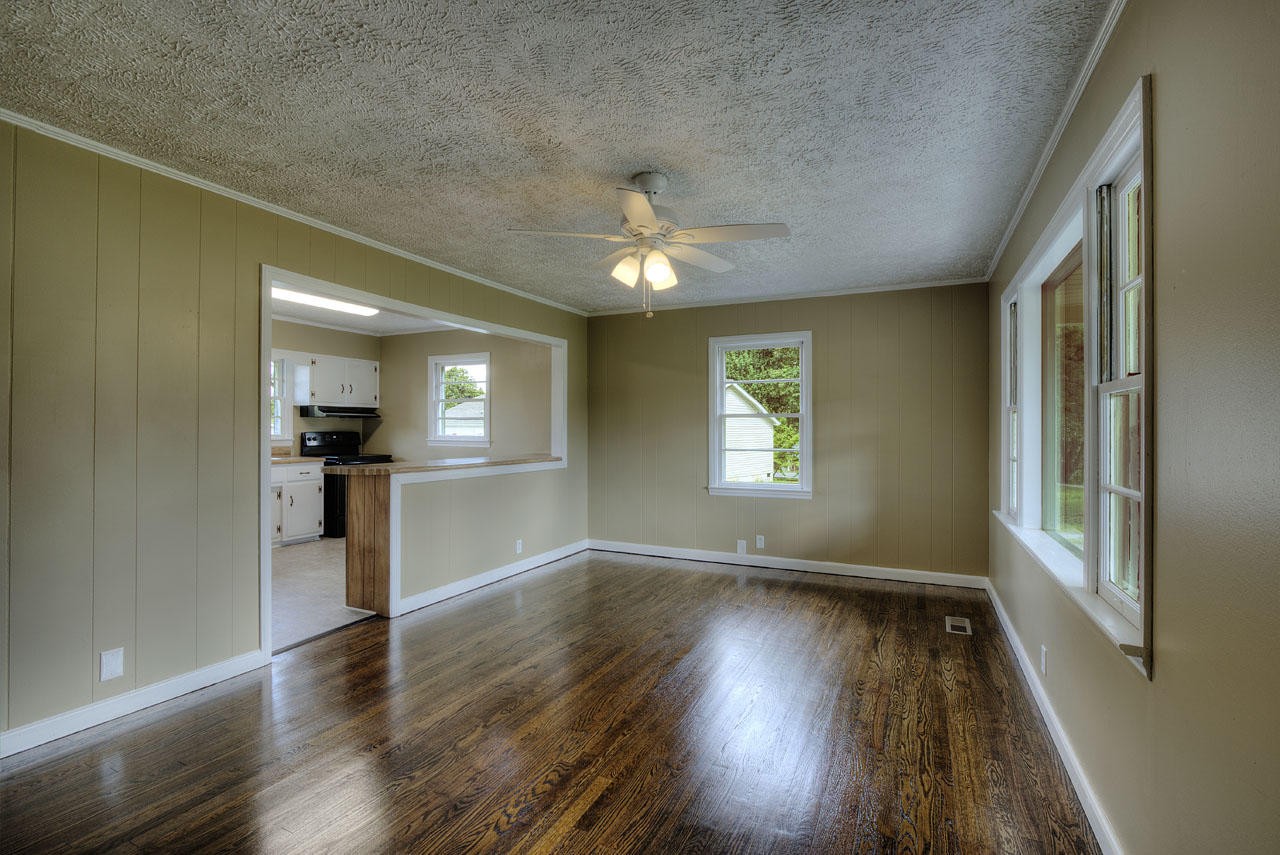 102 Stephens Road Greenback, TN 37742 - Photo 5 of 31 an empty room with wooden floor and windows