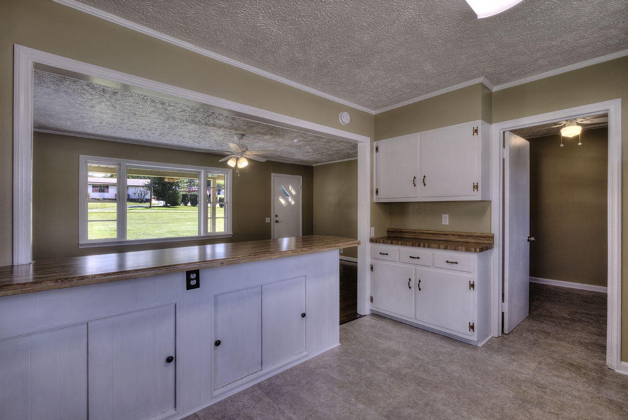102 Stephens Road Greenback, TN 37742 - Photo 7 of 31 a large kitchen with granite countertop a sink and white cabinets