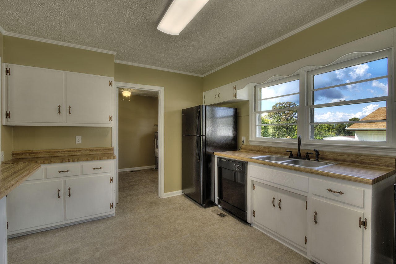 102 Stephens Road Greenback, TN 37742 - Photo 9 of 31 a kitchen with granite countertop cabinets stainless steel appliances and window