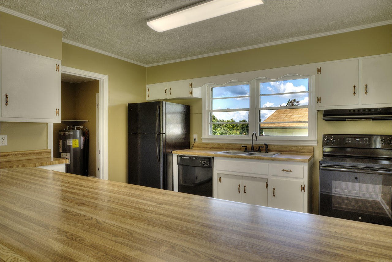 102 Stephens Road Greenback, TN 37742 - Photo 10 of 31 a kitchen with stainless steel appliances granite countertop a refrigerator a stove and a wooden floors