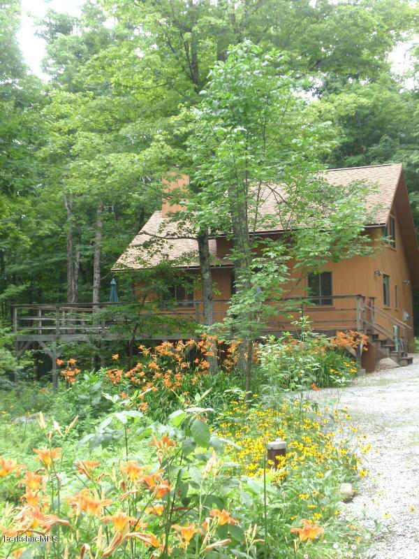 248 Stebbins Road Otis, MA 01253 - Photo 2 of 16 a backyard of a house with lots of green space and fountain in the back
