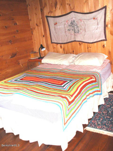 248 Stebbins Road Otis, MA 01253 - Photo 11 of 16 a bedroom with a bed and a painting on the wall