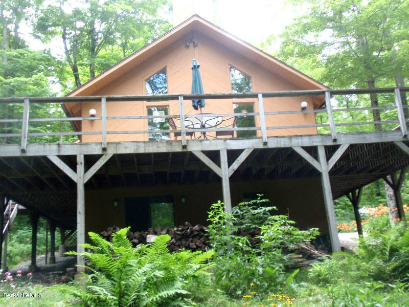 248 Stebbins Road Otis, MA 01253 - Photo 3 of 16 a front view of a house with balcony and garden