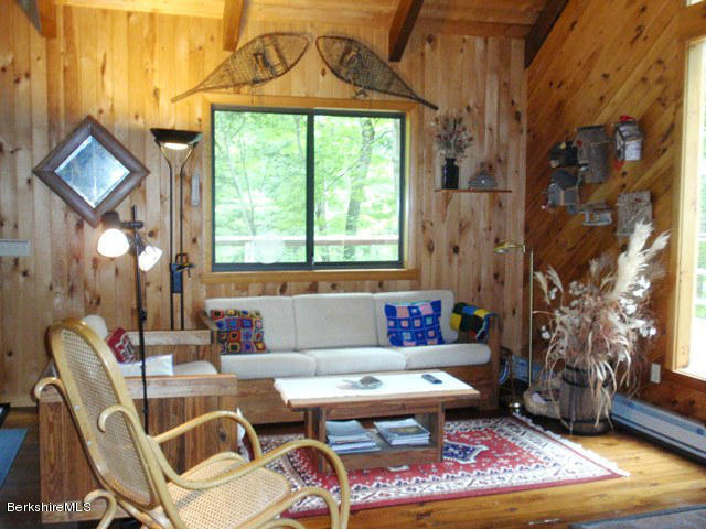 248 Stebbins Road Otis, MA 01253 - Photo 5 of 16 a living room with furniture a window and a dining table