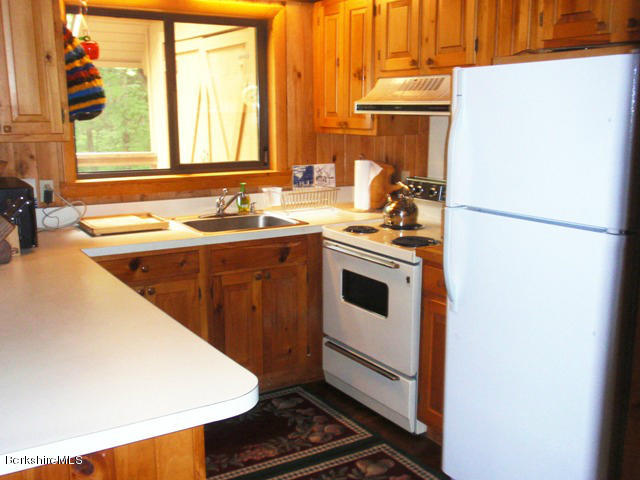 248 Stebbins Road Otis, MA 01253 - Photo 10 of 16 a kitchen with a sink a stove and a refrigerator