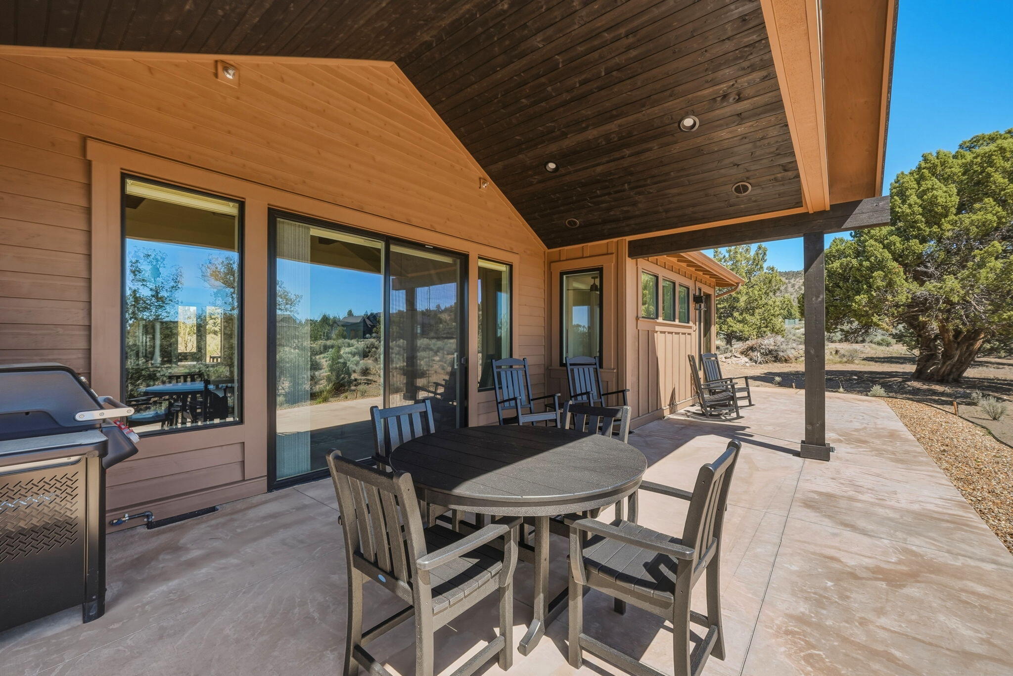 16636 South W Brasada Ranch Road, Unit CABIN 107 Powell Butte, OR 97753 - Photo 22 of 33 Large covered patio with BBQ, outdoor seating, and hot tub