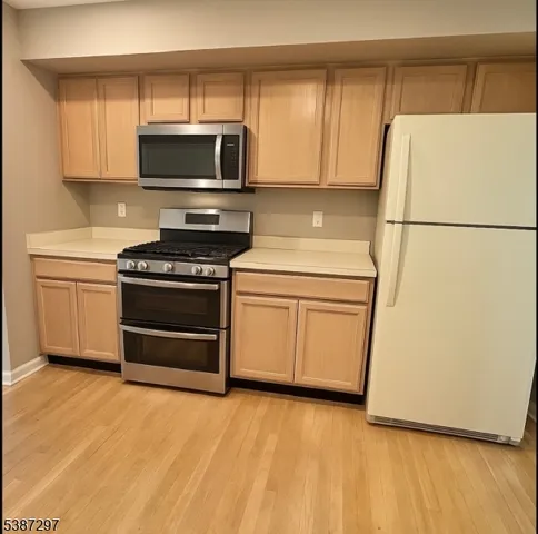 a kitchen with a stove a microwave and a refrigerator