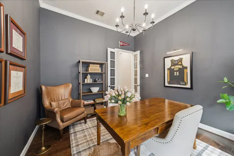 a kitchen with stainless steel appliances granite countertop a stove a sink a microwave a refrigerator and chairs