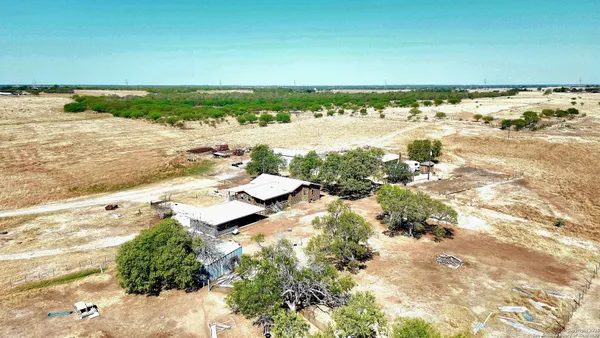 a view of a house with swimming pool and sitting area