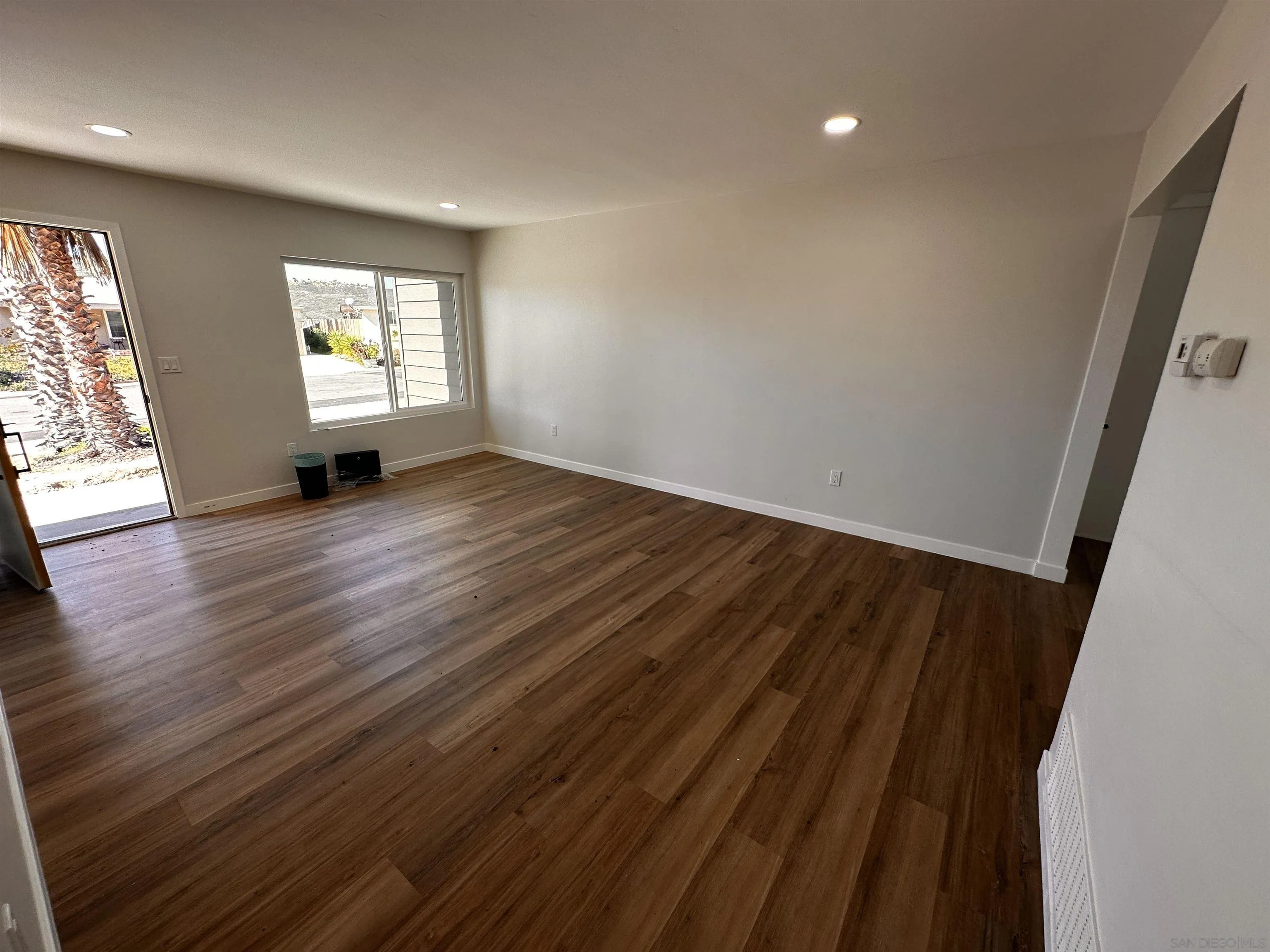 12733 McFeron Road Poway, CA 92064 - Photo 17 of 69 an empty room with wooden floor and windows