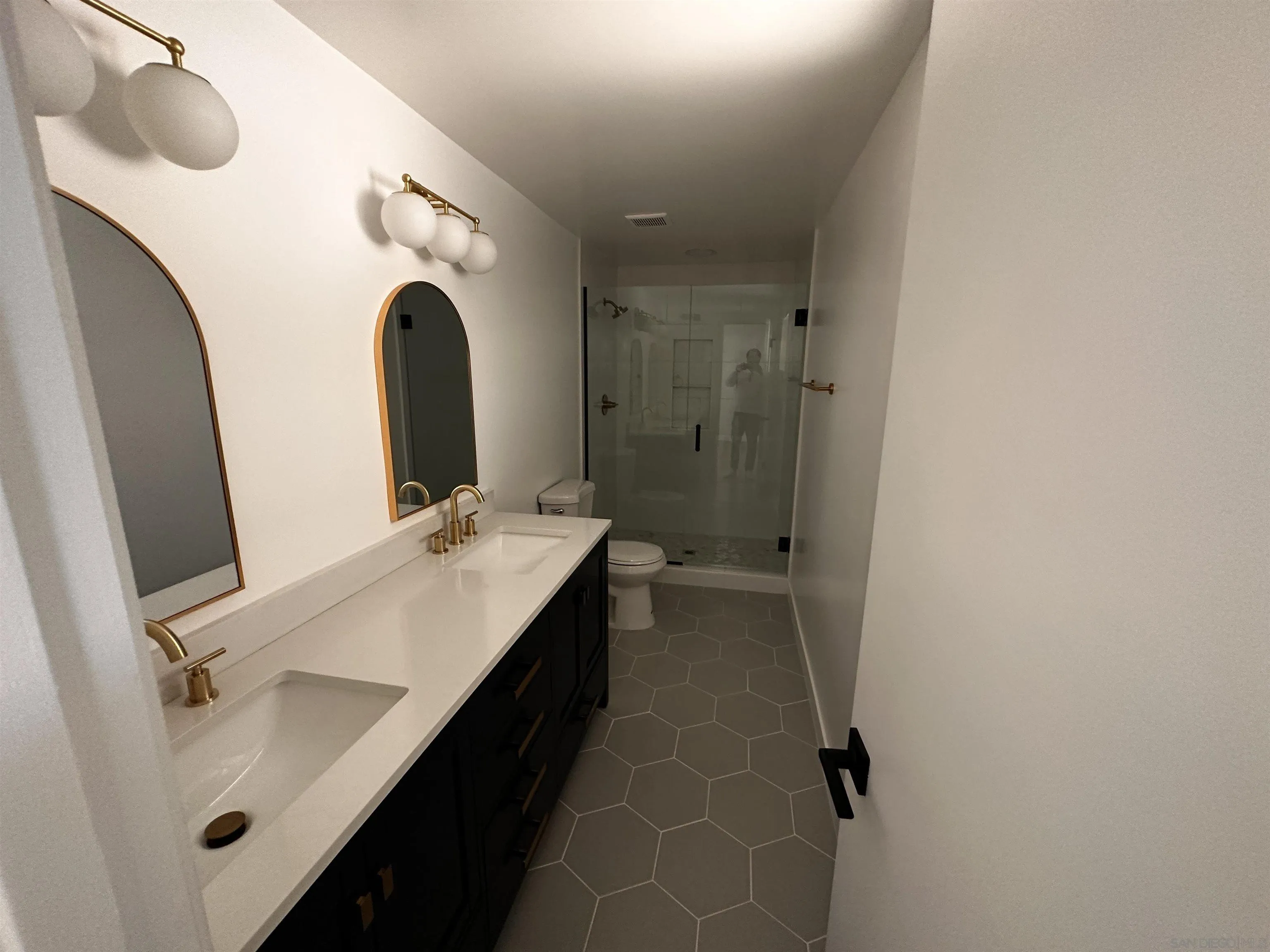 12733 McFeron Road Poway, CA 92064 - Photo 21 of 69 a bathroom with a double vanity sink mirror and toilet