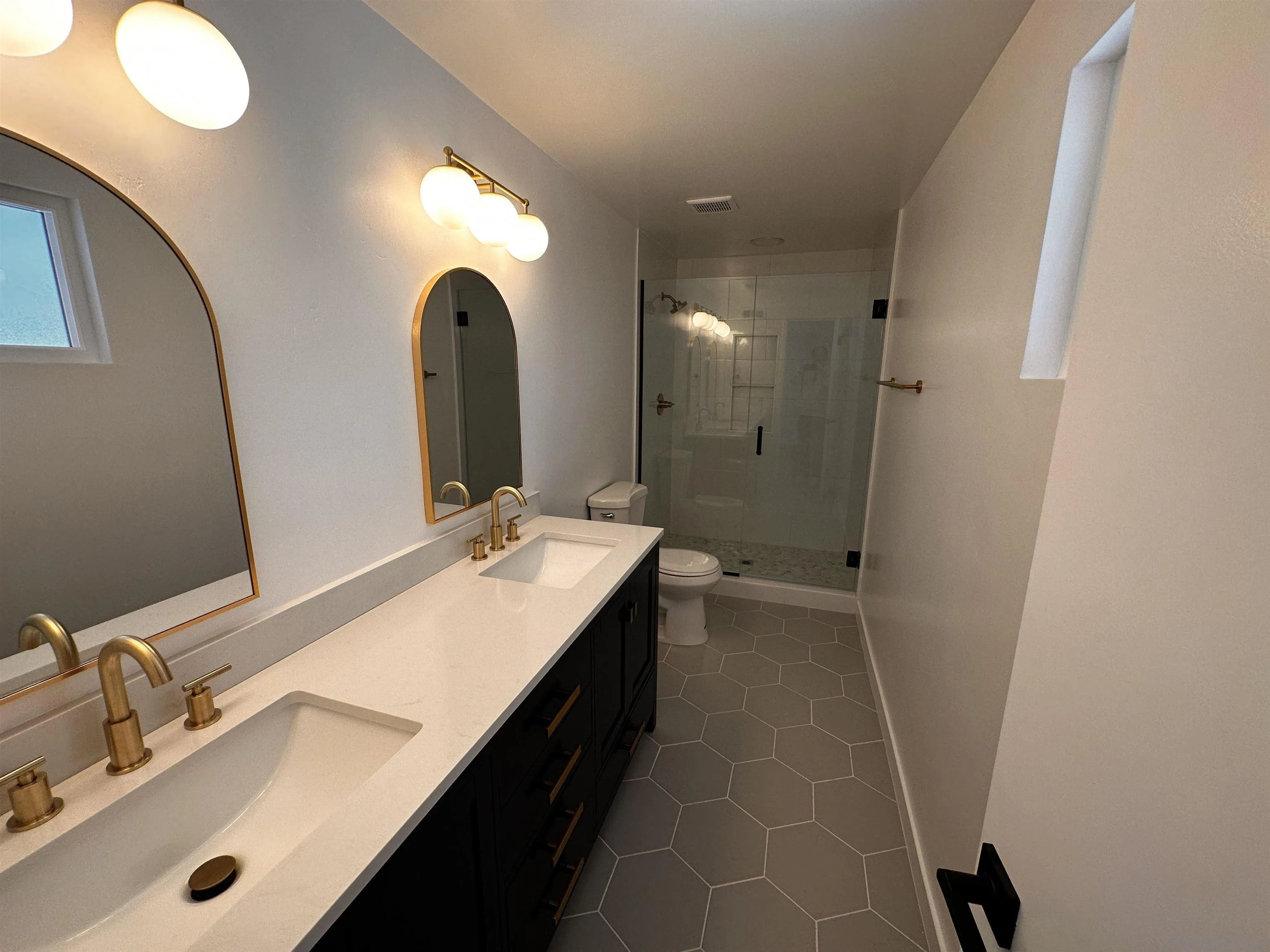 12733 McFeron Road Poway, CA 92064 - Photo 22 of 69 a bathroom with a double vanity sink and a mirror