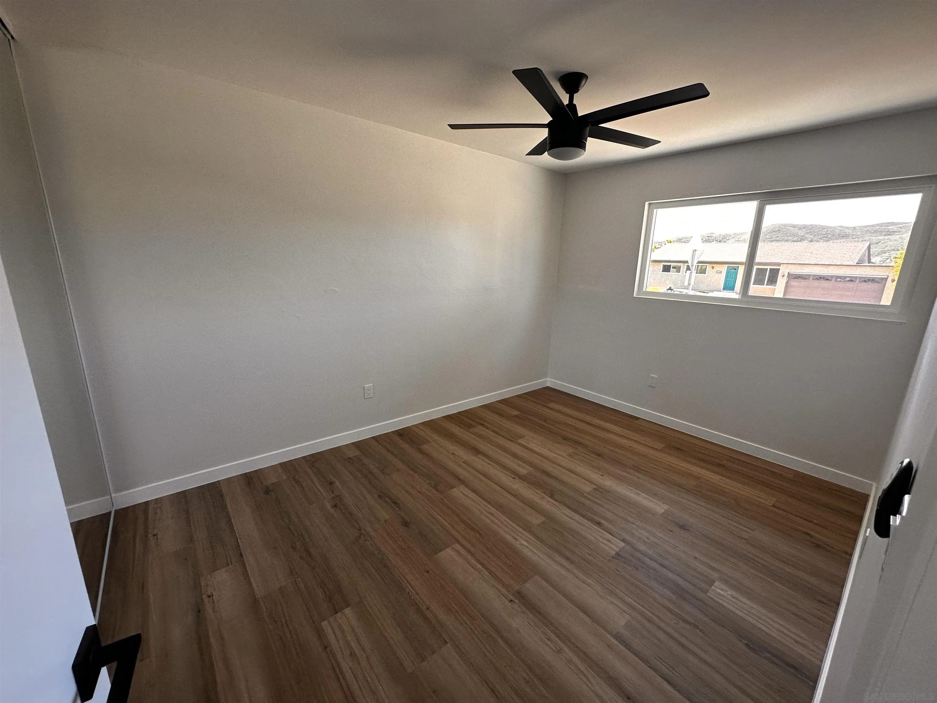 12733 McFeron Road Poway, CA 92064 - Photo 29 of 69 a view of a ceiling fan with wooden floor
