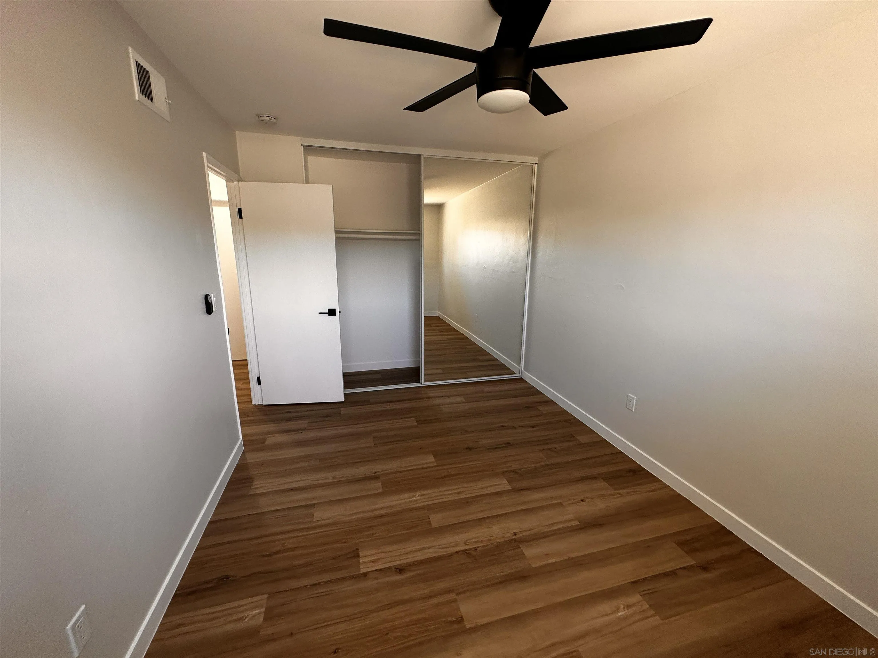 12733 McFeron Road Poway, CA 92064 - Photo 30 of 69 a view of a hallway with wooden floor
