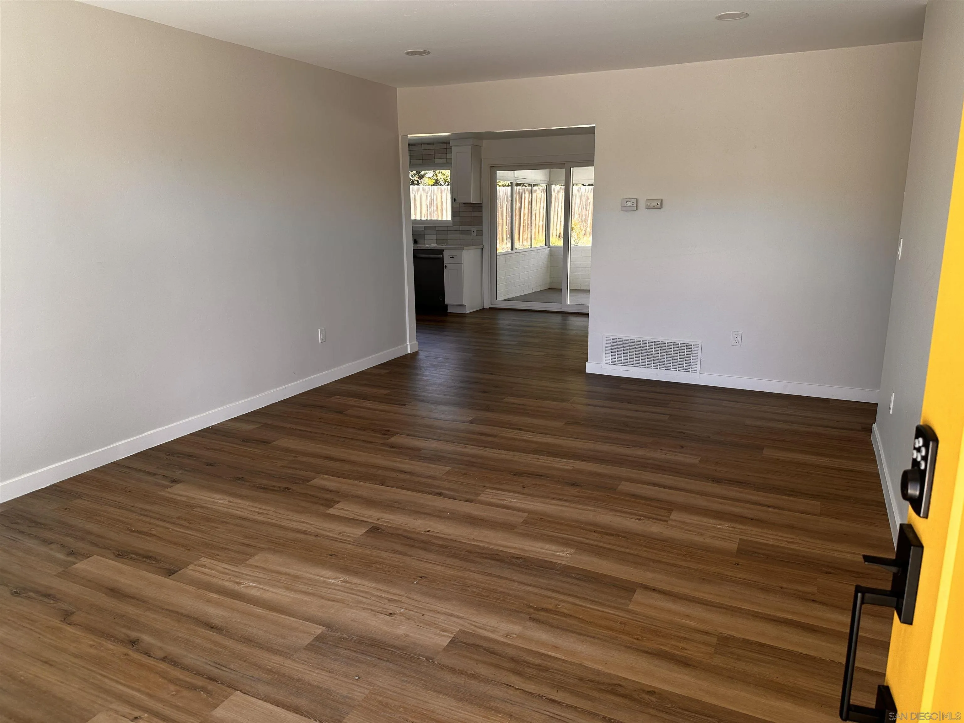 12733 McFeron Road Poway, CA 92064 - Photo 3 of 69 a view of an empty room with wooden floor and a window