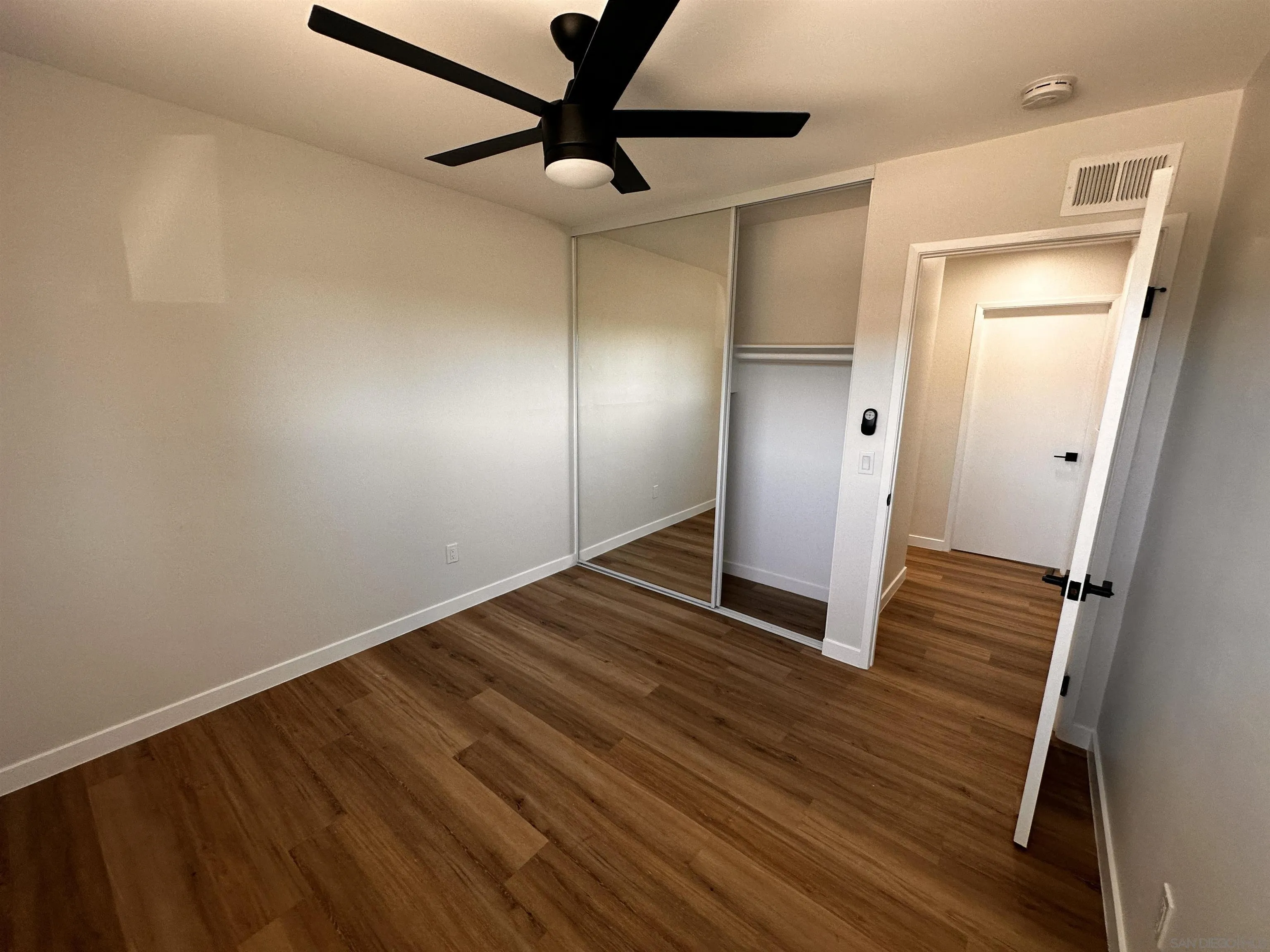 12733 McFeron Road Poway, CA 92064 - Photo 32 of 69 a view of a hallway with wooden floor