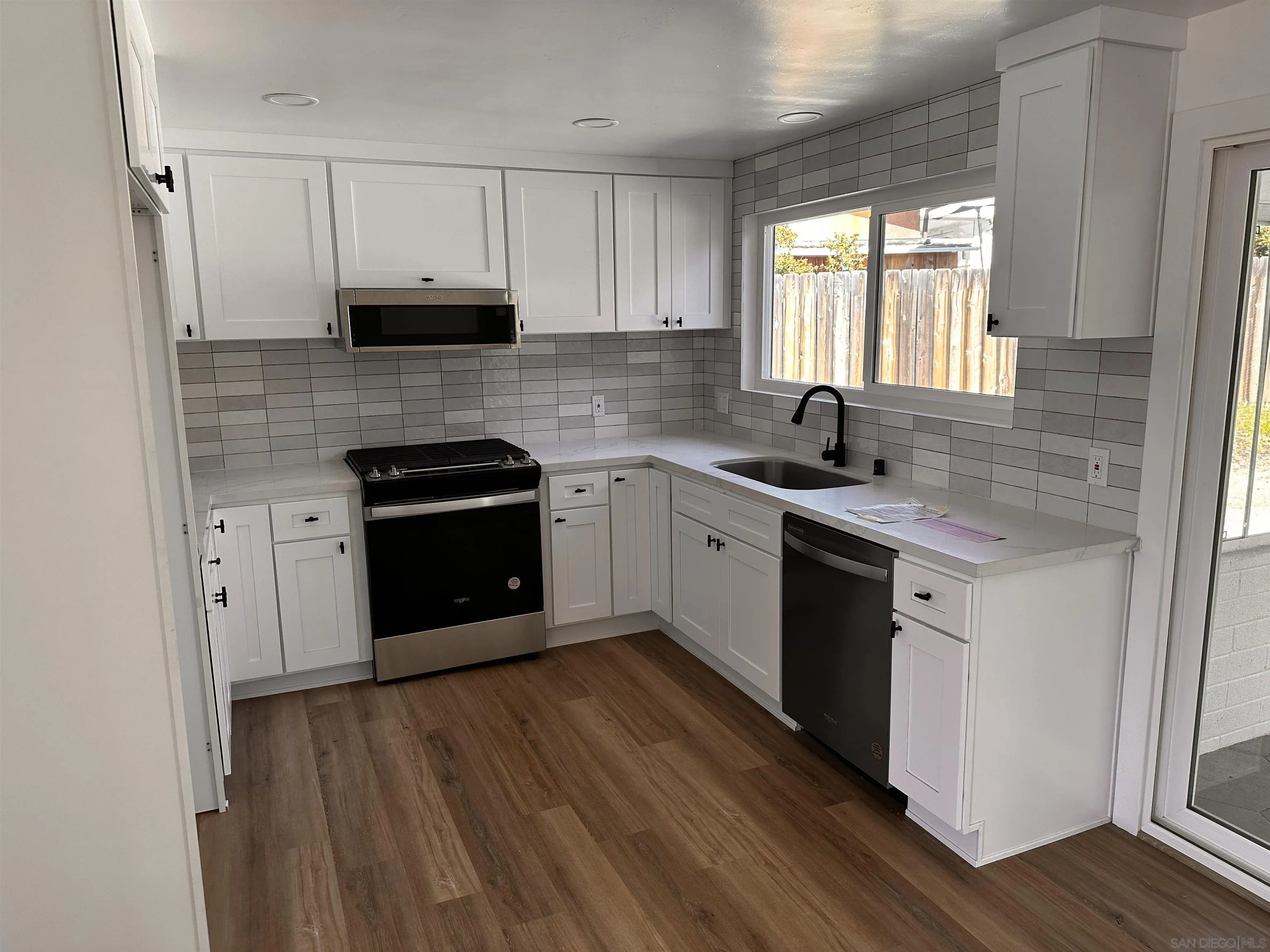 12733 McFeron Road Poway, CA 92064 - Photo 5 of 69 a kitchen with stainless steel appliances granite countertop a sink a stove a refrigerator and cabinets