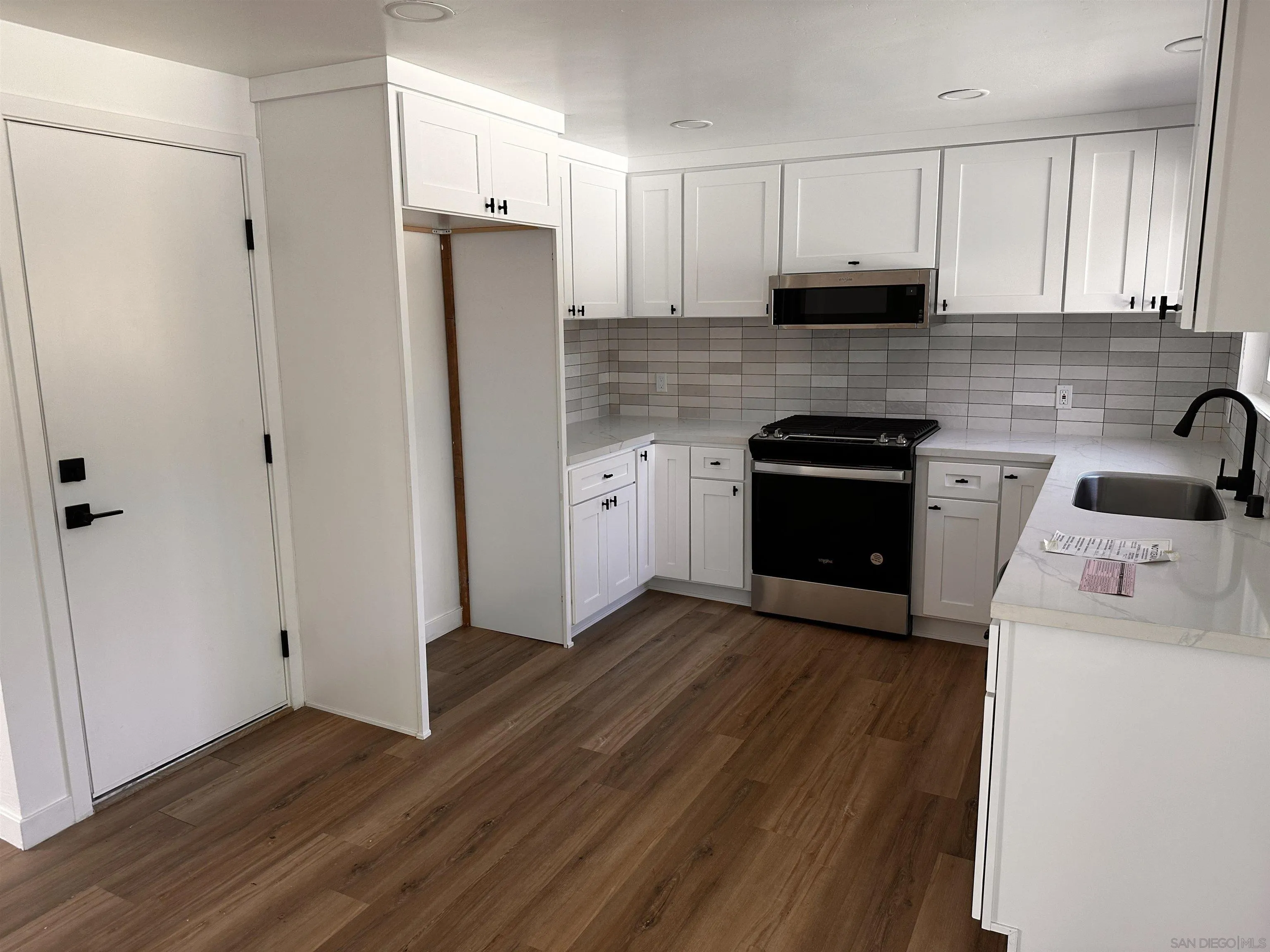 12733 McFeron Road Poway, CA 92064 - Photo 6 of 69 a kitchen with a refrigerator sink and cabinets