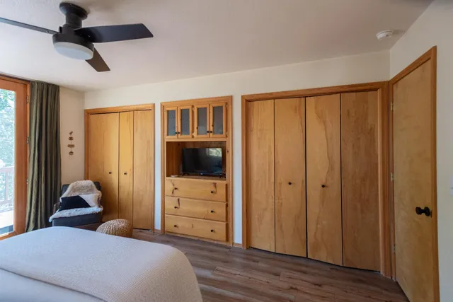 a bedroom with a bed and wooden floor