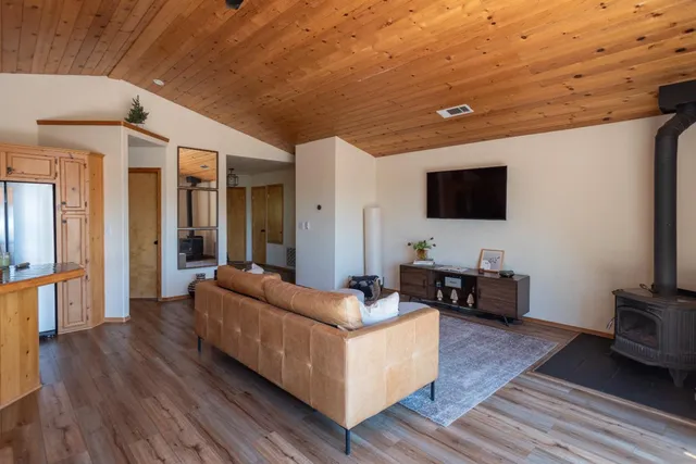 a view of a hallway with wooden floor and closet