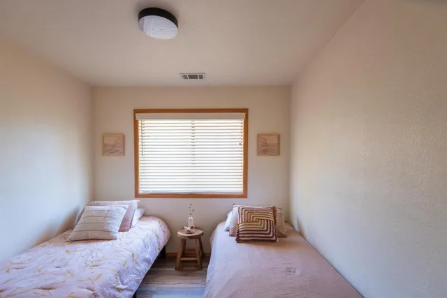 a very nice looking room with wooden floor and a window