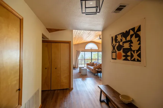 a living room with furniture wooden floor and a flat screen tv