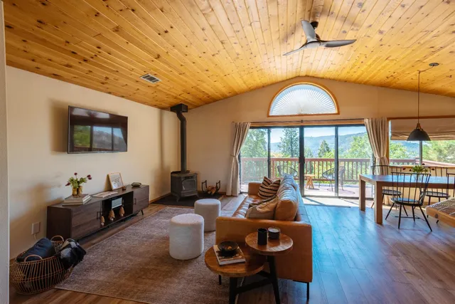 a living room with furniture a fireplace and a table
