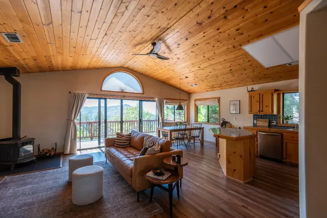 a kitchen with stainless steel appliances granite countertop a kitchen island wooden floors and white cabinets