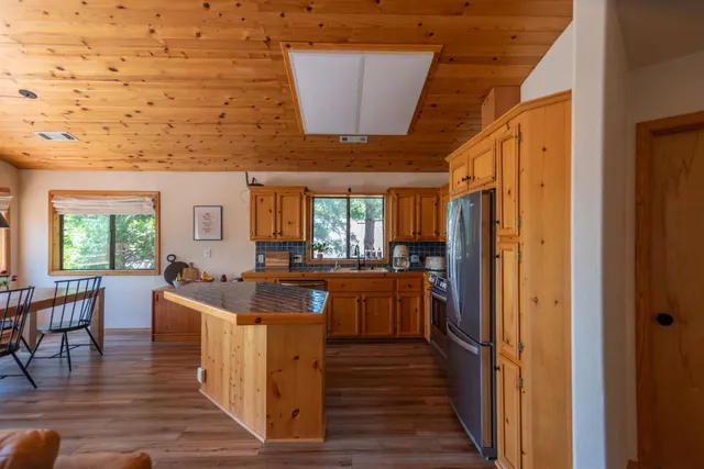 a view of a hallway with wooden floor and a living room