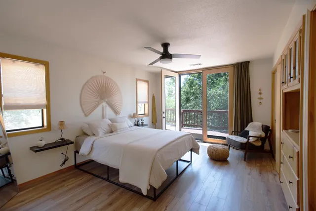 a bedroom with a bed and wooden floor