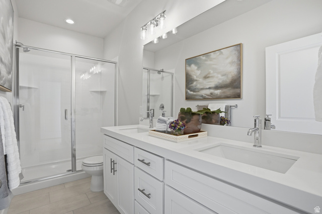 7338 South Seven Tree Lane, Unit 75 Midvale, UT 84047 - Photo 17 of 30 Bathroom featuring double vanity and a stall shower