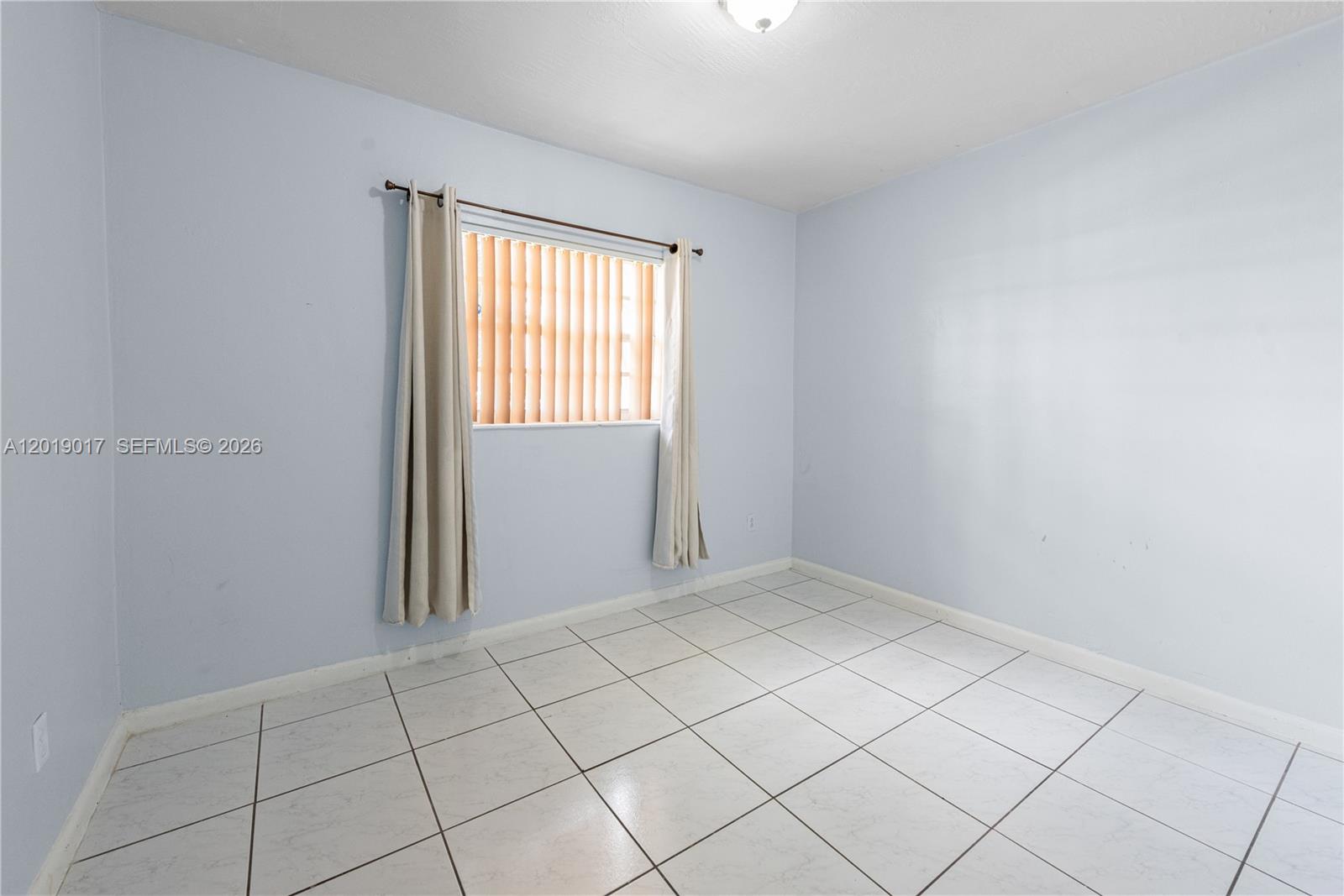 731 Northwest 17th Street Homestead, FL 33030 - Photo 12 of 29 an empty room with windows