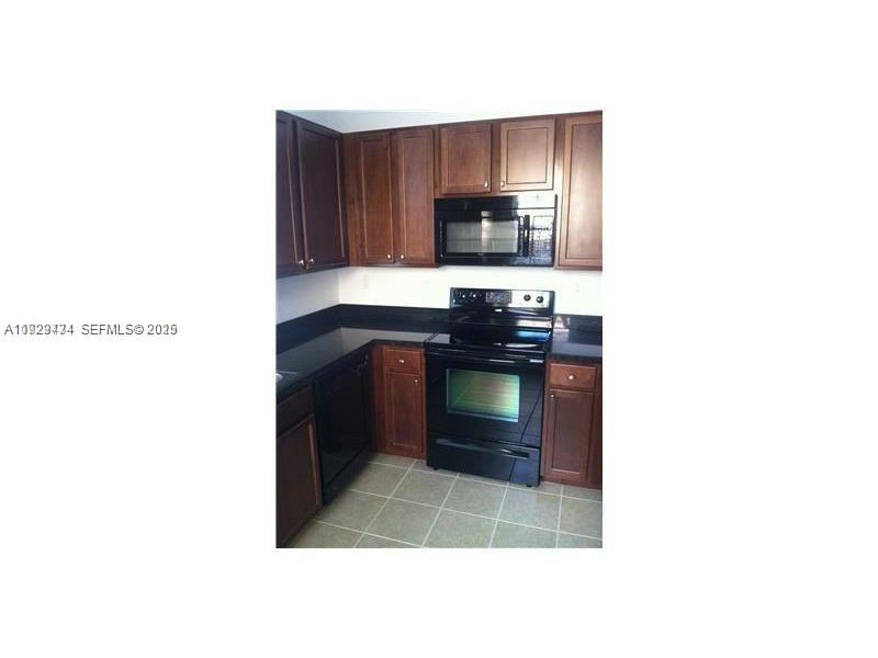 1131 Southwest 147th Avenue Pembroke Pines, FL 33027 - Photo 10 of 15 a kitchen with a sink and a stove