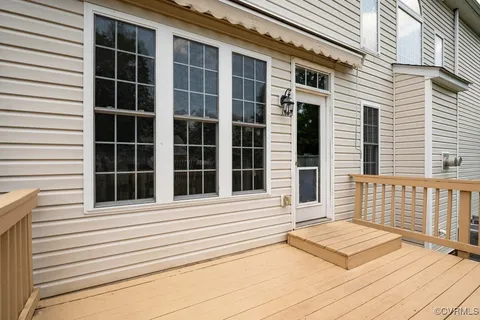 a balcony with wooden floor and fence