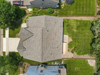 an aerial view of residential house with yard
