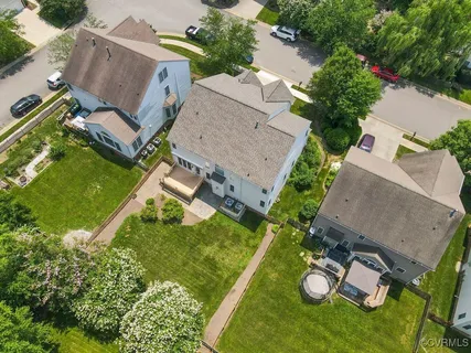 an aerial view of a house with a yard