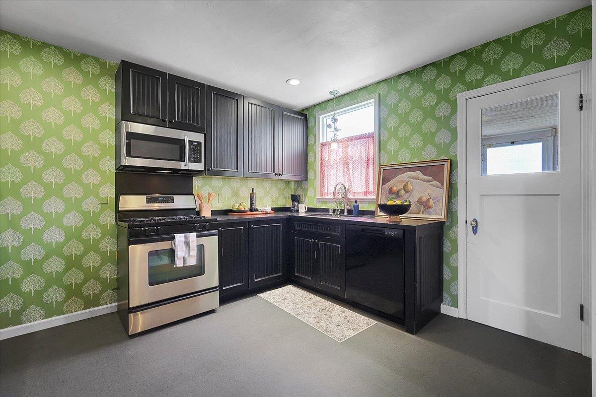 1102 Barry Road Yuba City, CA 95991 - Photo 23 of 88 a kitchen with a sink stove and microwave