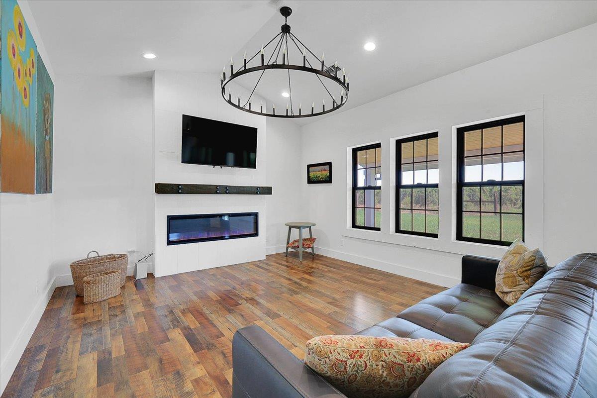 1102 Barry Road Yuba City, CA 95991 - Photo 46 of 88 a living room with furniture a flat screen tv and a fireplace