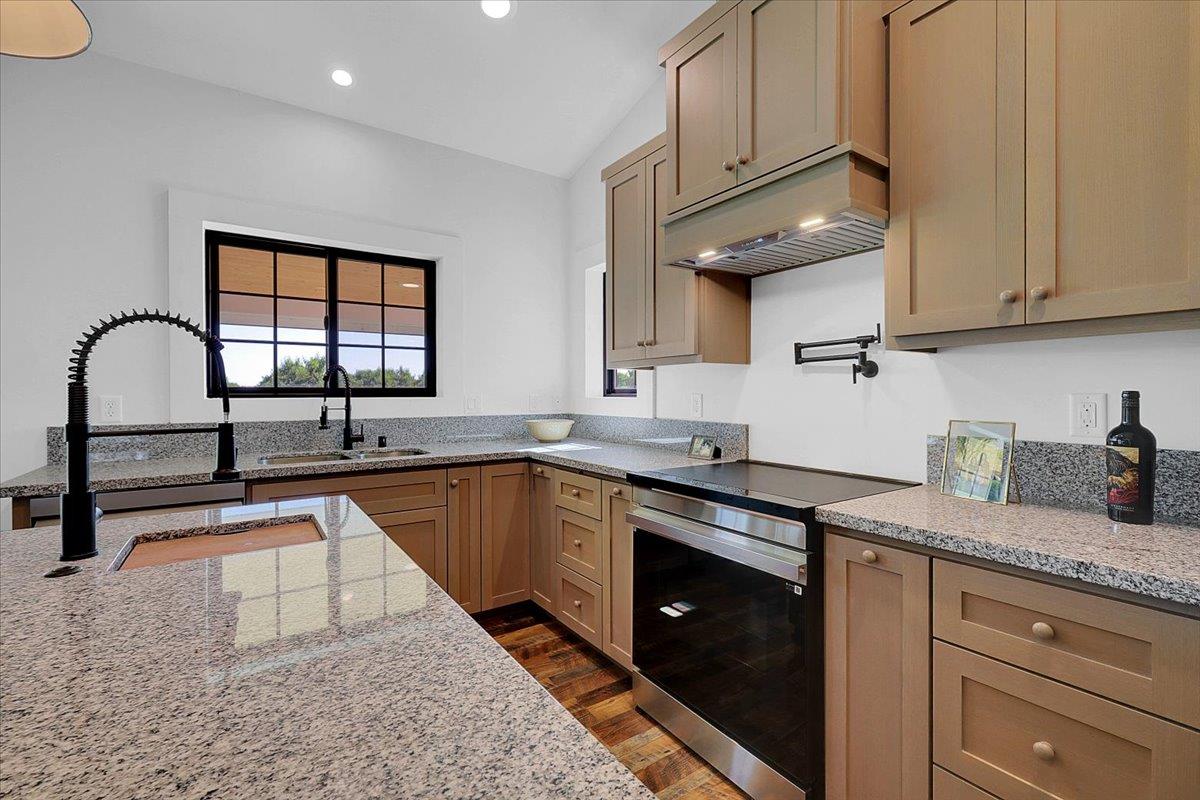 1102 Barry Road Yuba City, CA 95991 - Photo 55 of 88 a kitchen with granite countertop a stove a sink and a microwave