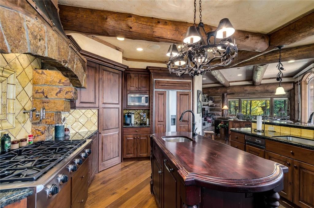 189 Juniata Circle Breckenridge, CO 80424 - Photo 13 of 35 a kitchen with stainless steel appliances granite countertop a sink a stove and a wooden cabinets