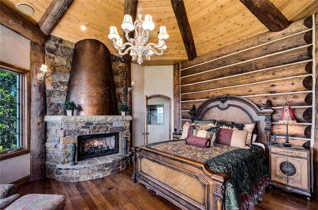189 Juniata Circle Breckenridge, CO 80424 - Photo 19 of 35 a bedroom with a bed and a fireplace