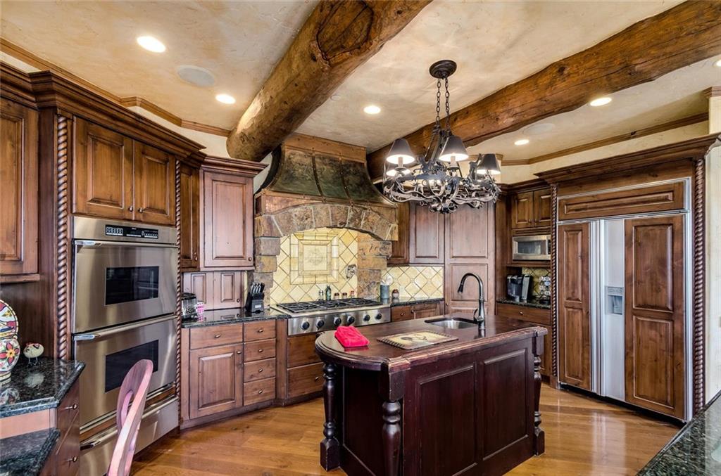 189 Juniata Circle Breckenridge, CO 80424 - Photo 3 of 35 a kitchen with stainless steel appliances granite countertop a stove and cabinets