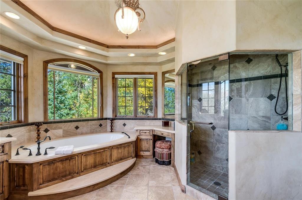 189 Juniata Circle Breckenridge, CO 80424 - Photo 21 of 35 a spacious bathroom with a tub and a large mirror