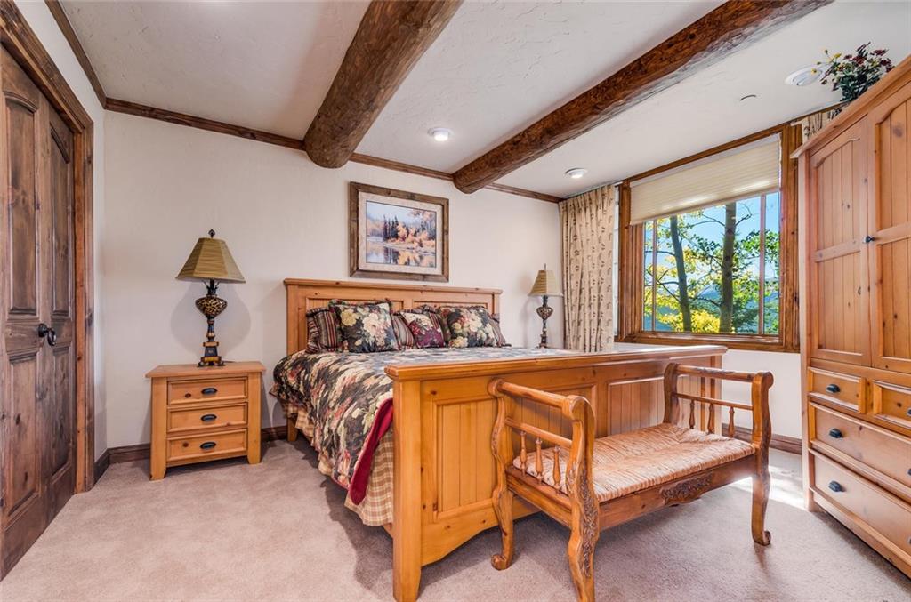 189 Juniata Circle Breckenridge, CO 80424 - Photo 30 of 35 a spacious bedroom with a bed and a window