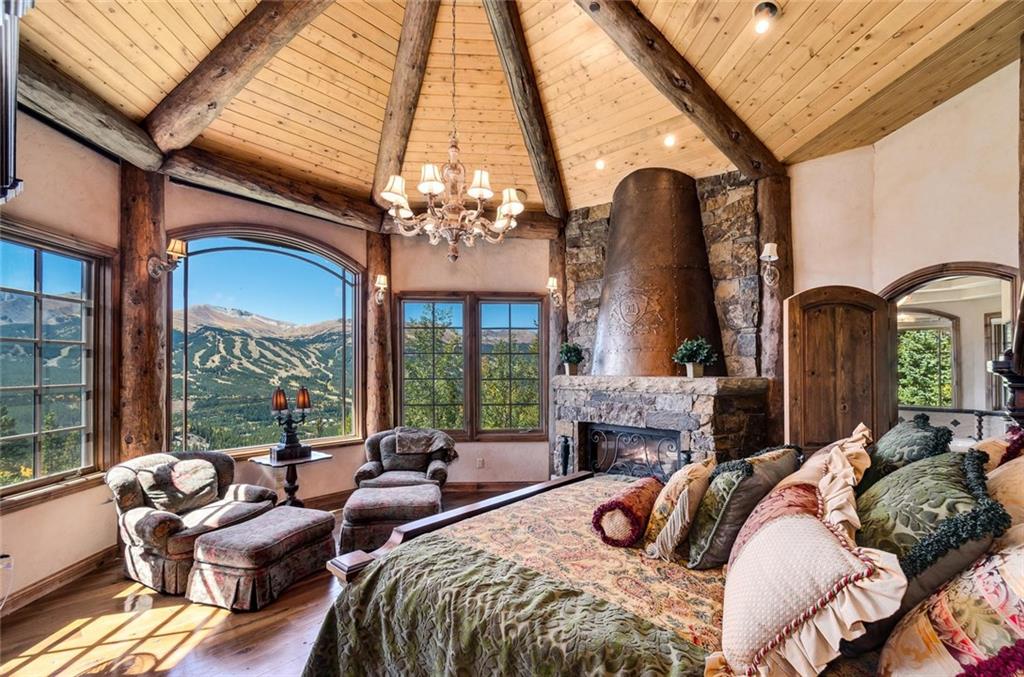 189 Juniata Circle Breckenridge, CO 80424 - Photo 4 of 35 a bedroom with furniture a fireplace and a large window