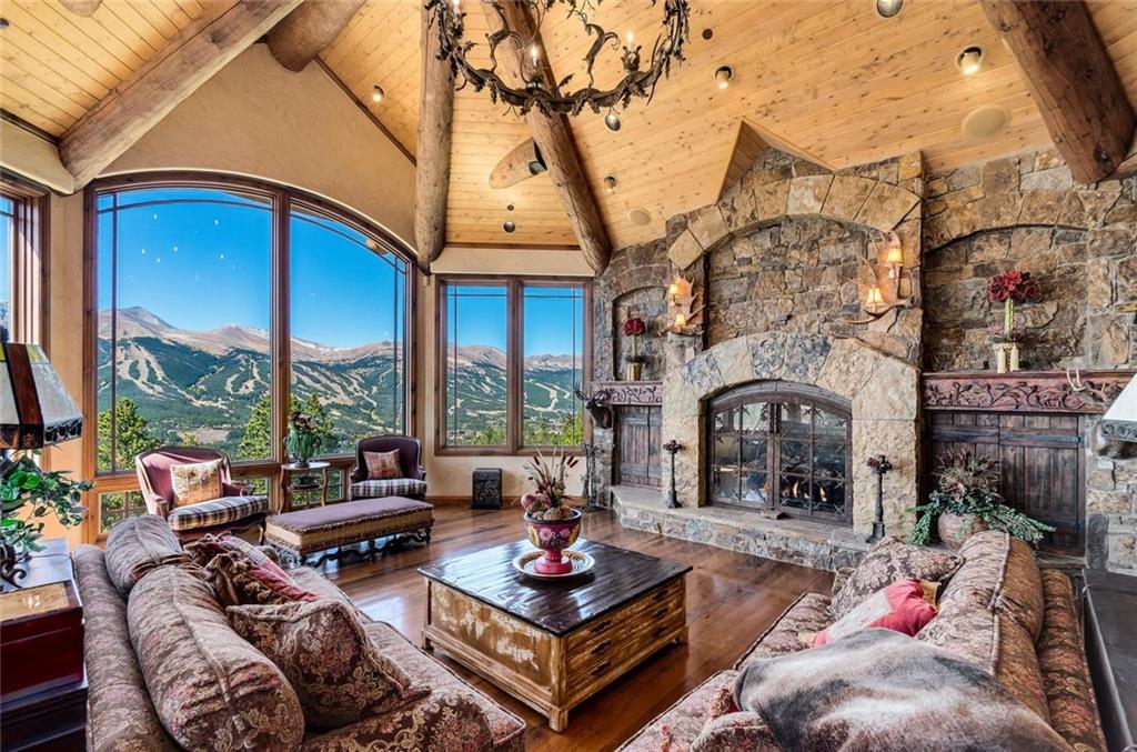 189 Juniata Circle Breckenridge, CO 80424 - Photo 7 of 35 a living room with furniture a fireplace and a large window