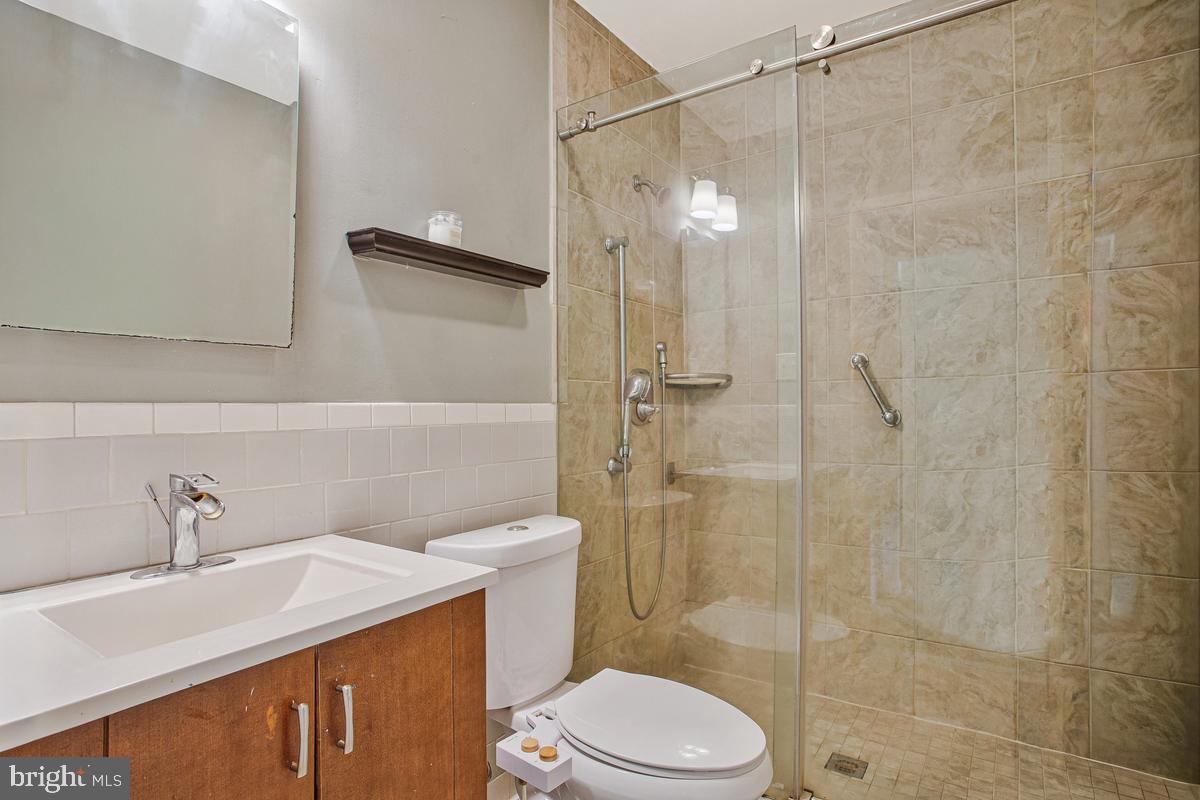 976 Shore Acres Road Arnold, MD 21012 - Photo 28 of 40 a bathroom with a sink toilet and shower