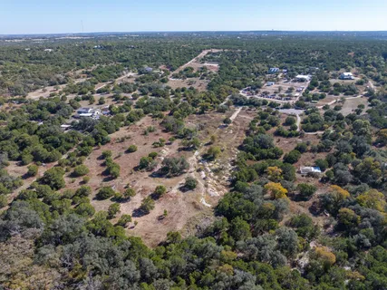 an aerial view of house with yard and mountain view in back
