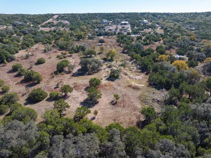 an aerial view of house with yard and mountain view in back