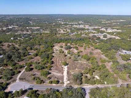 an aerial view of residential building with green space